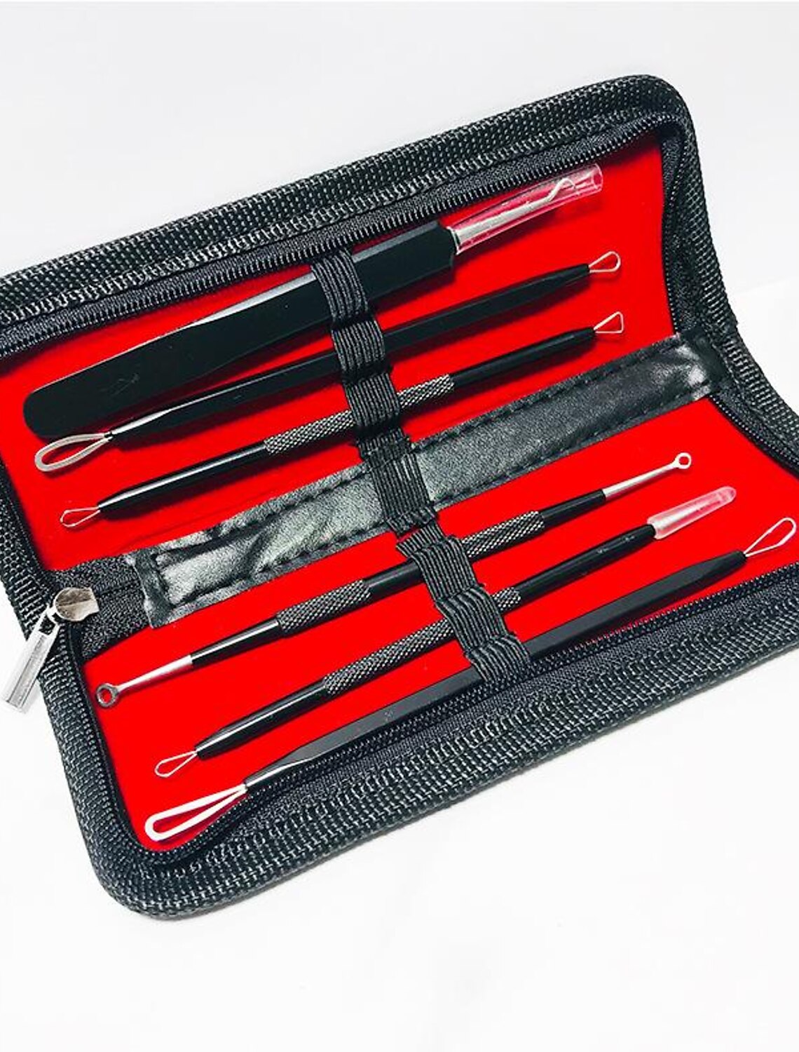 Assortment of silver acne needle tools for facial treatment.