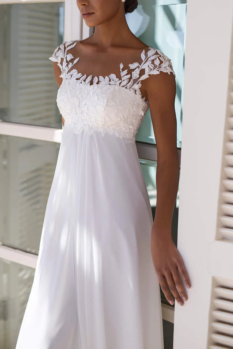 Close-up of the lace appliques and short sleeves on the A-line wedding dress.