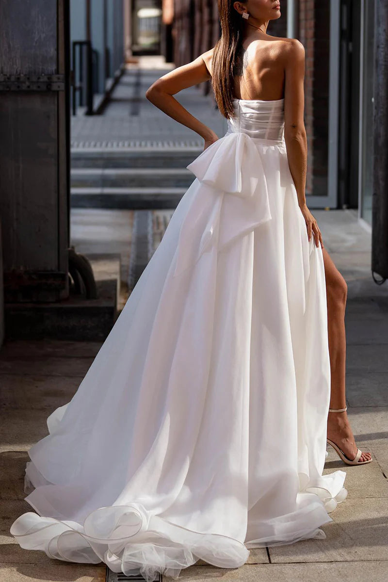 Model wearing an A-line boho strapless split wedding dress, front view.