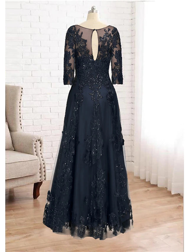 Close-up of lace and sequin appliques on a floor-length formal gown.
