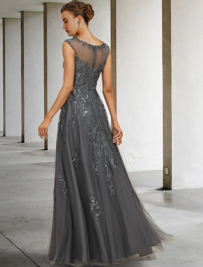 Back view of an A-line sleeveless lace and tulle gown with intricate beading and a flowing skirt.