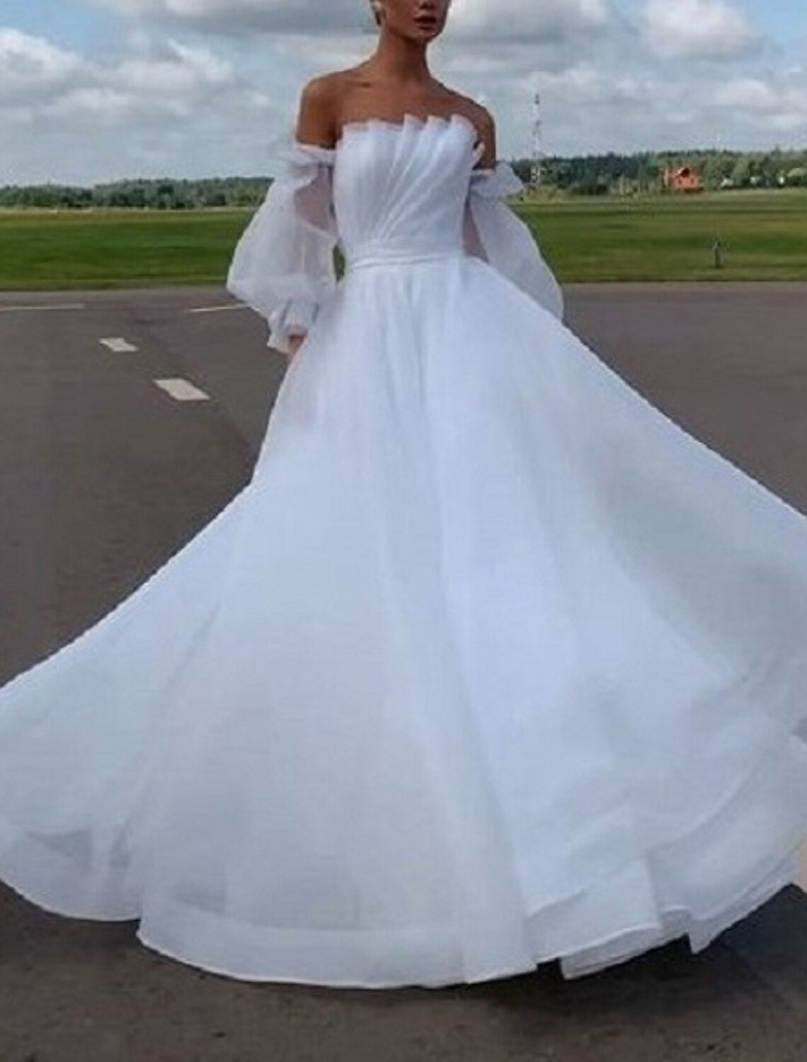 Back view of A-Line Off Shoulder Long Sleeve Organza Beach Wedding Gown with court train.