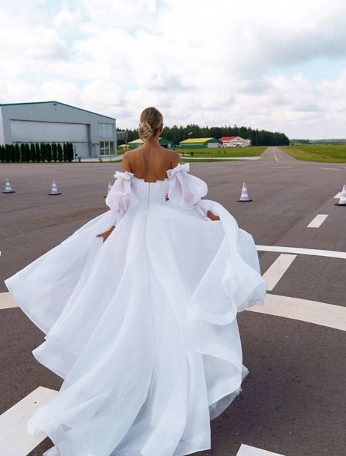 Close-up of the Off Shoulder neckline and long sleeves of the Organza Wedding Gown.