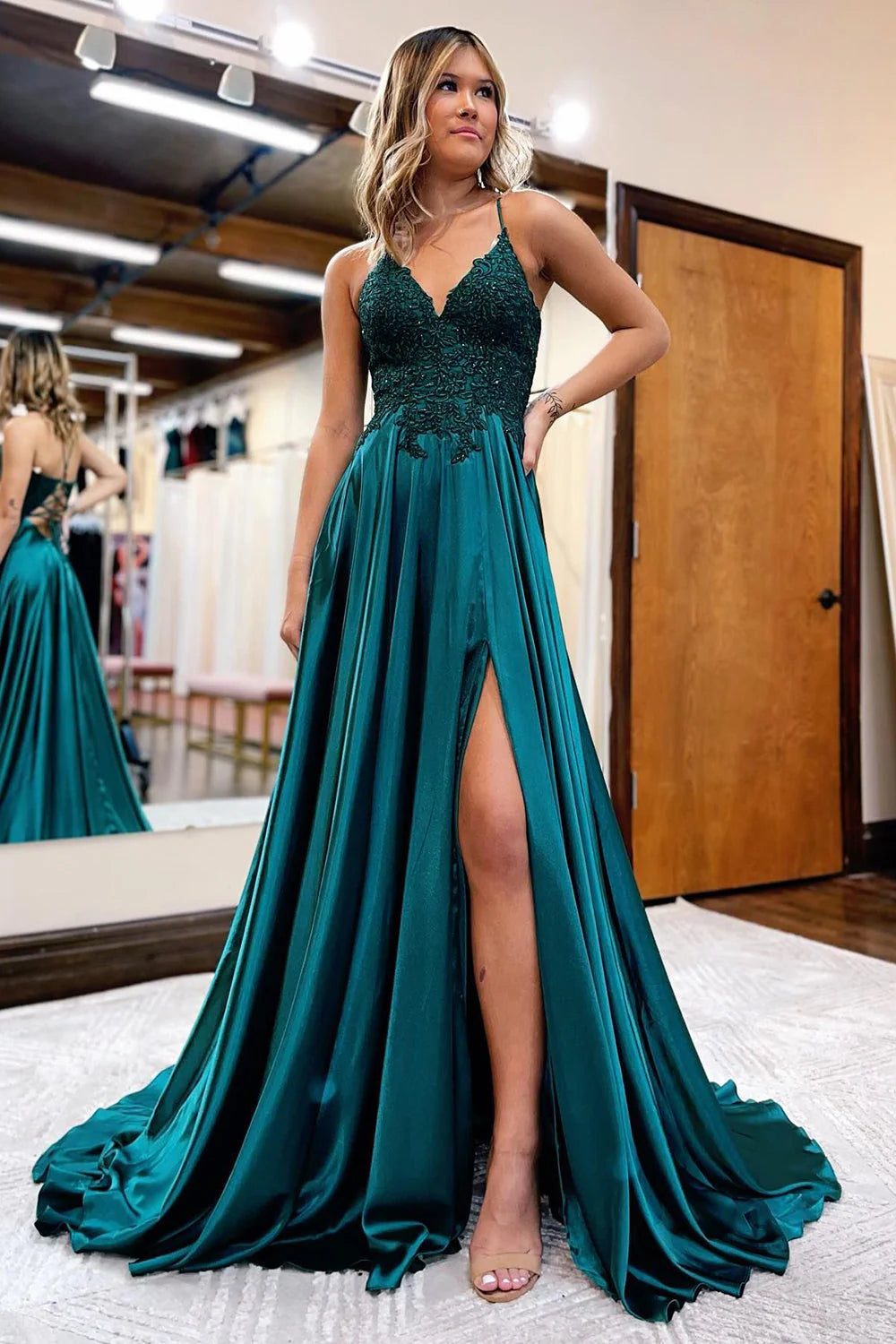 Woman walking in an A-Line satin prom dress with a high slit, side view.