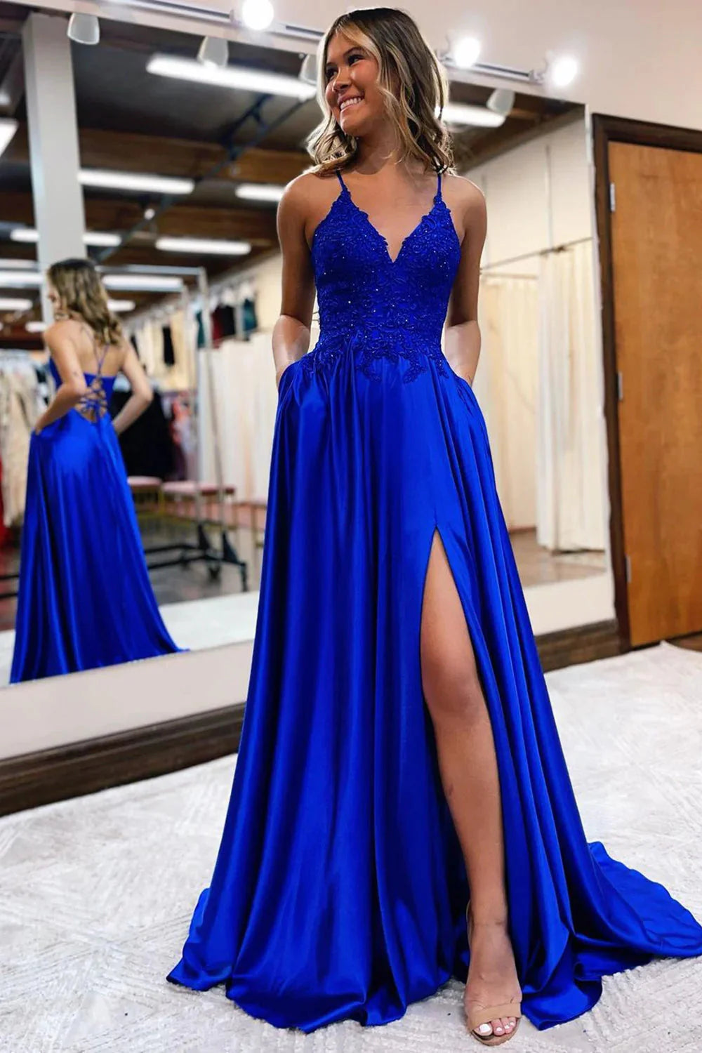 Detail of the high slit on an A-Line satin prom dress.