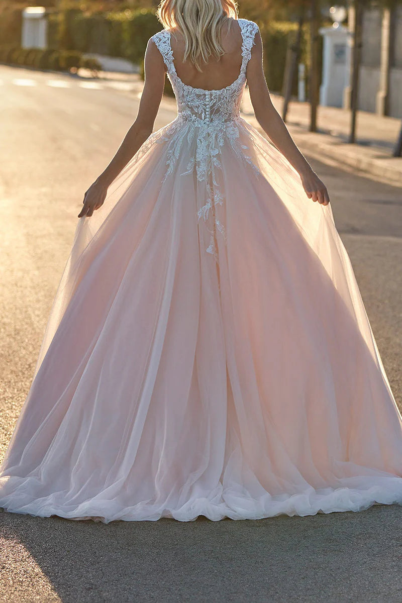 Back view of an A-line wedding dress featuring a scoop neck, lace appliques, and a sweep train.