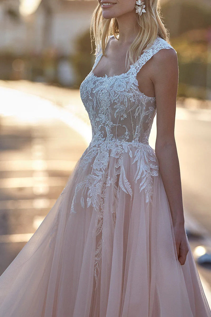 Side view of a bride wearing an A-line scoop neck wedding dress with delicate lace appliques.