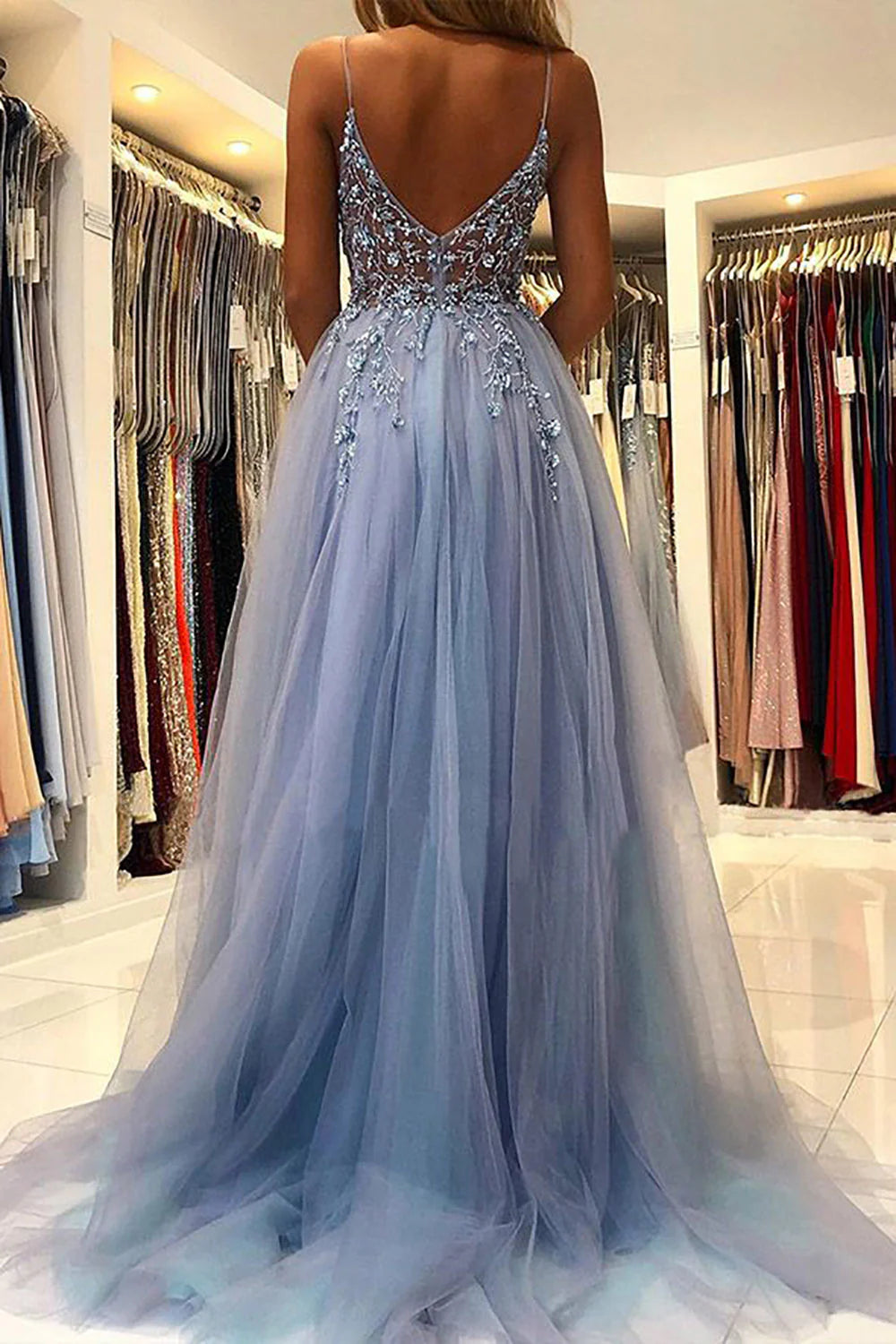 Close-up view of the A-line spaghetti strap prom dress, highlighting the delicate appliques and flowing fabric.