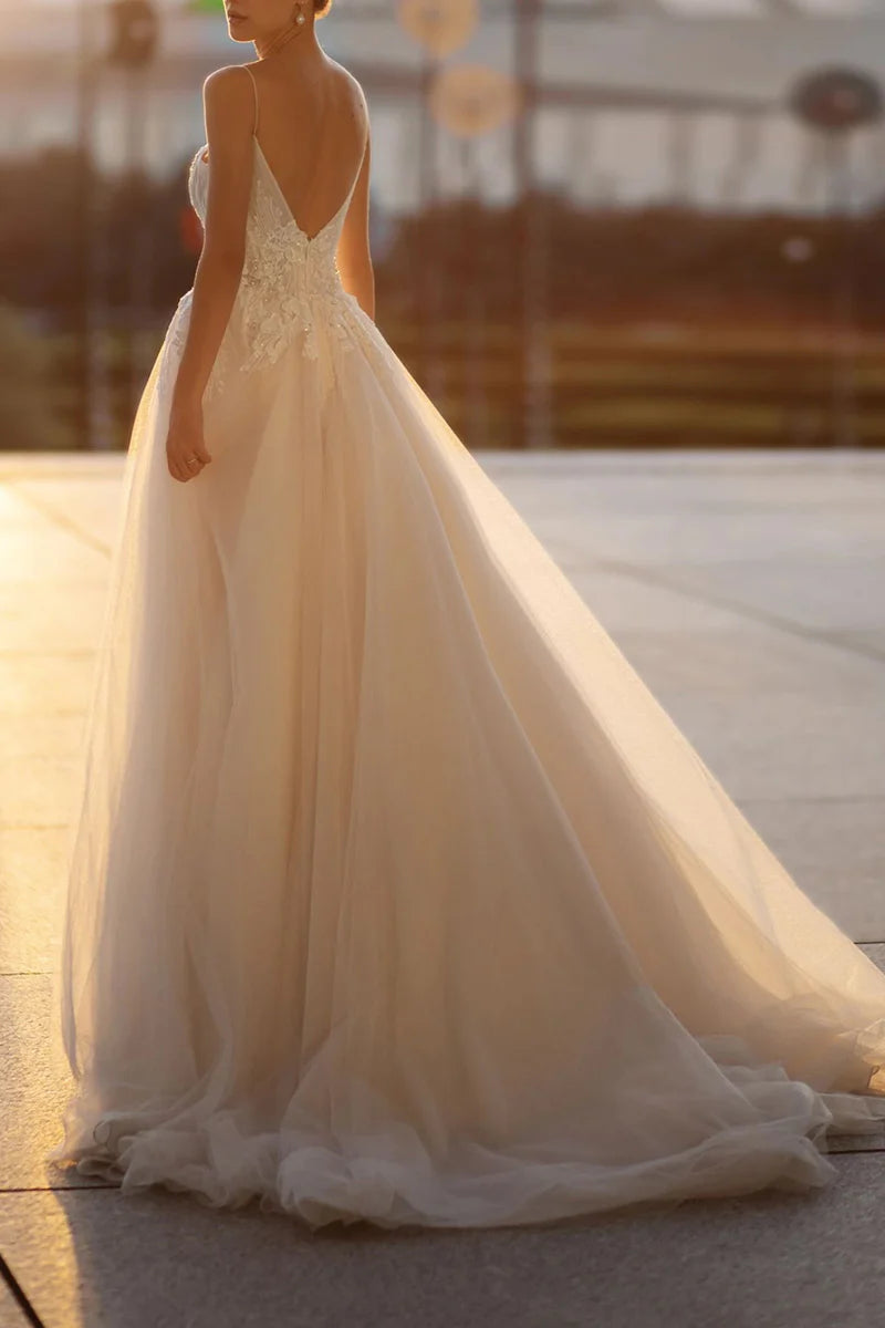 Elegant A-line bridal gown with delicate lace details and spaghetti straps.