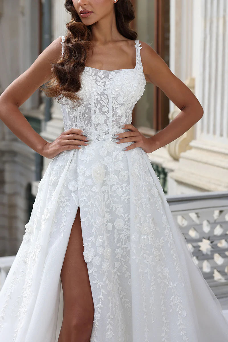 Elegant A-line bridal gown with intricate lace appliques and a flowing court train.