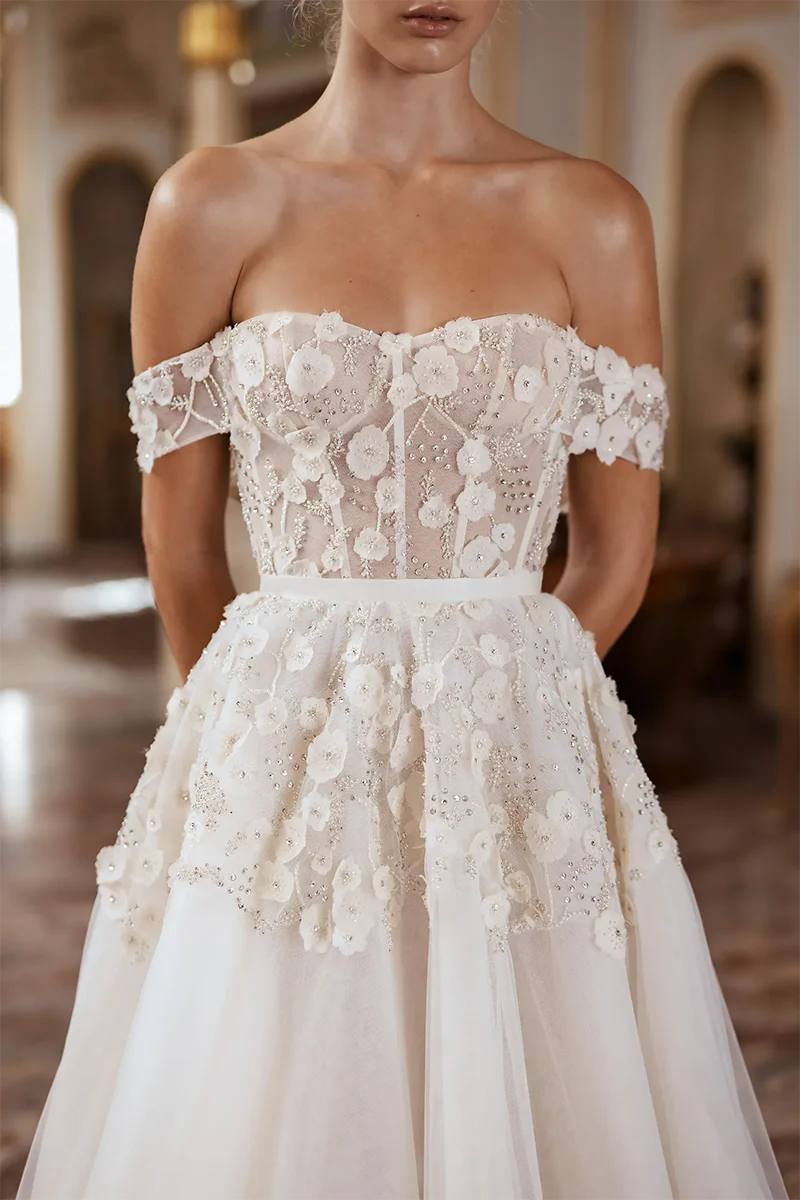 Bride in A-line wedding dress with flowing court train.