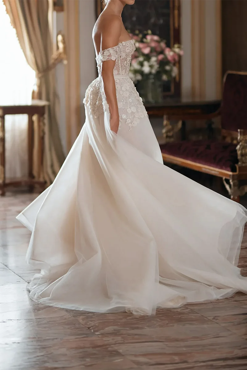 Close-up of intricate appliques on the wedding dress bodice.