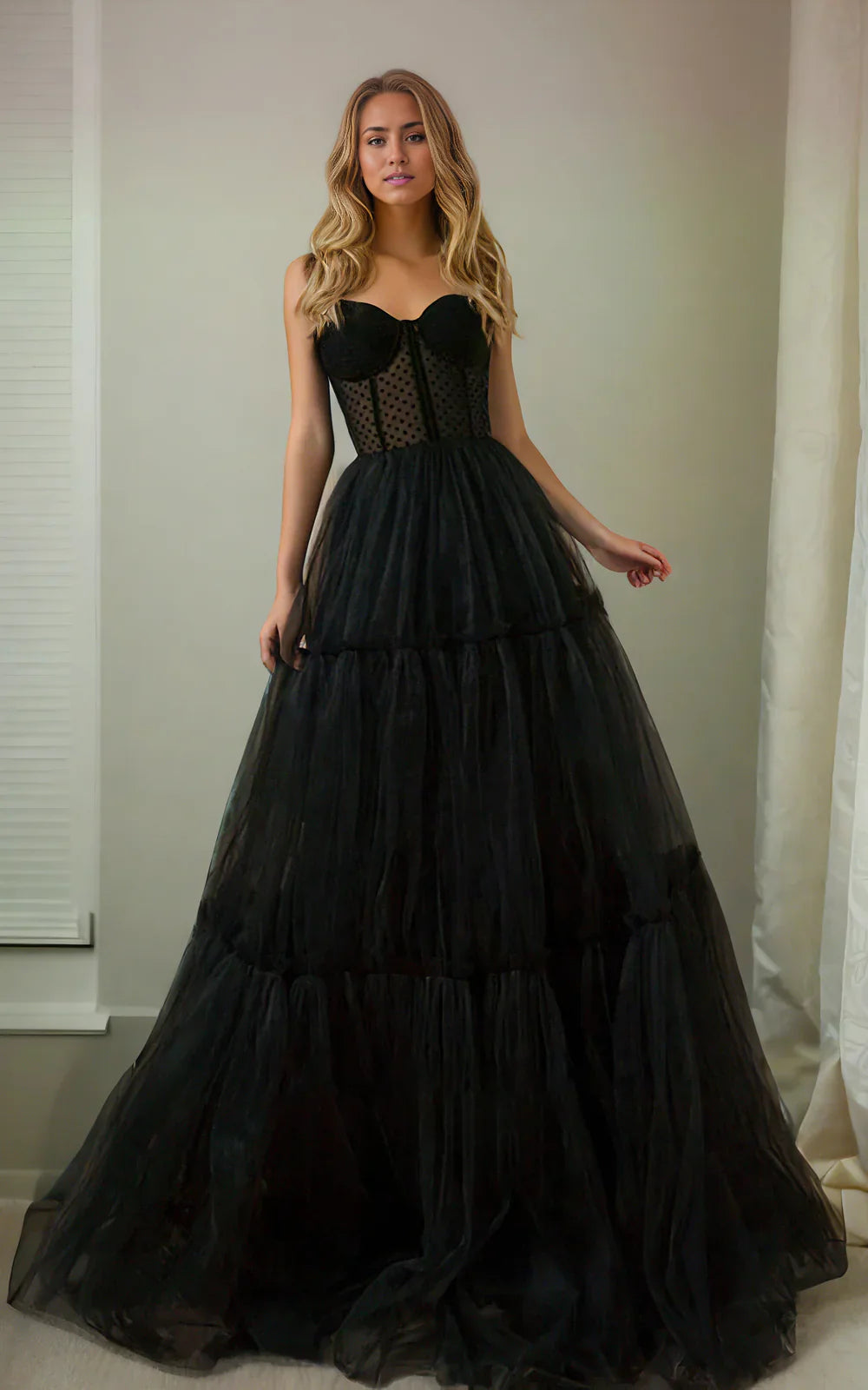 Front view of an A-line sweetheart tulle wedding dress with spaghetti straps and a sweep train.
