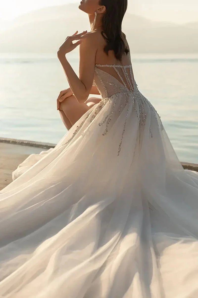 Close-up of the sweetheart neckline and delicate beadwork on the wedding dress.
