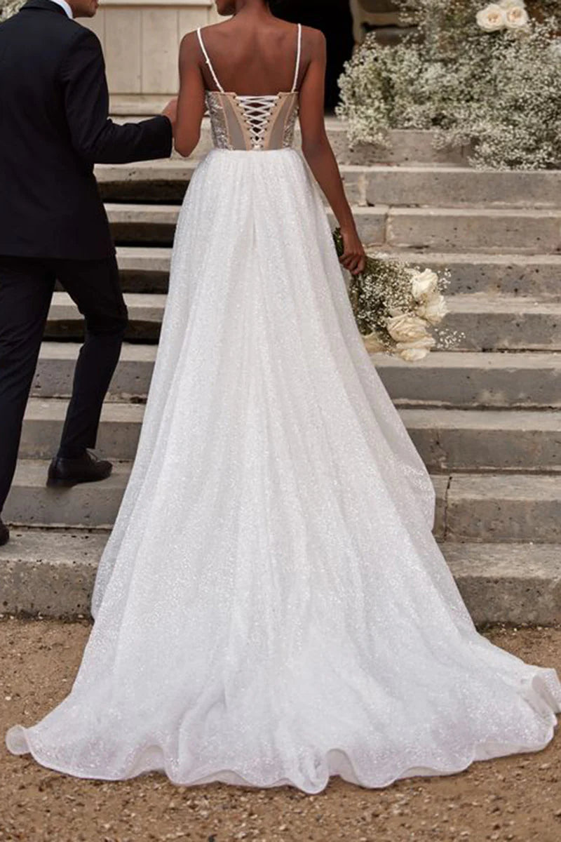 Back view of an A-line wedding dress, showcasing the sweep train and beaded details.