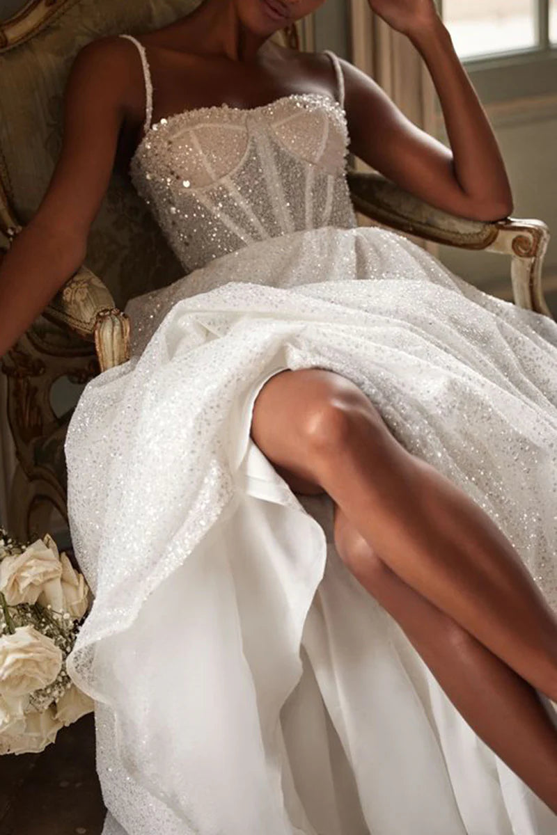 Side profile of the A-line wedding dress, highlighting its silhouette and graceful sweep train.