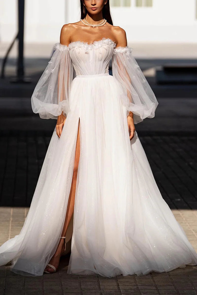 Elegant A-line wedding dress with sweetheart neckline and long sleeves, adorned with appliques.