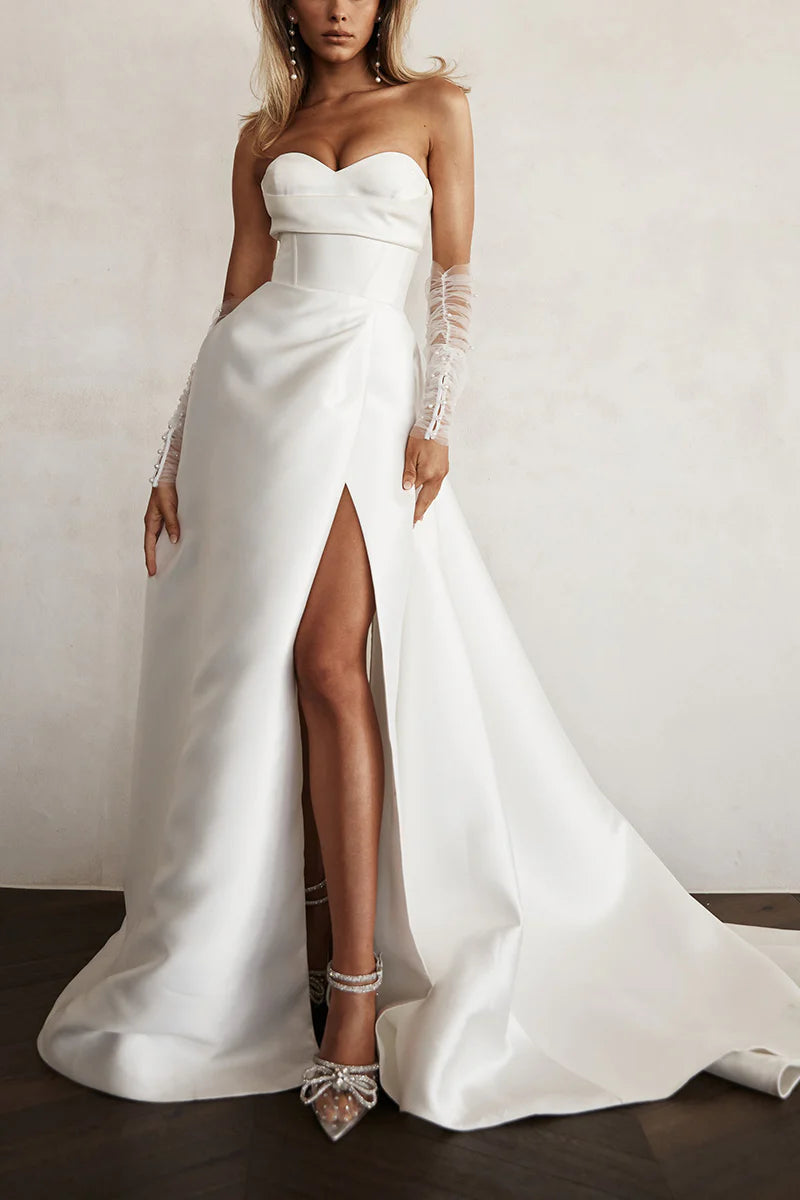 Model wearing an A-line sweetheart long sleeve satin pleated wedding dress, front view.