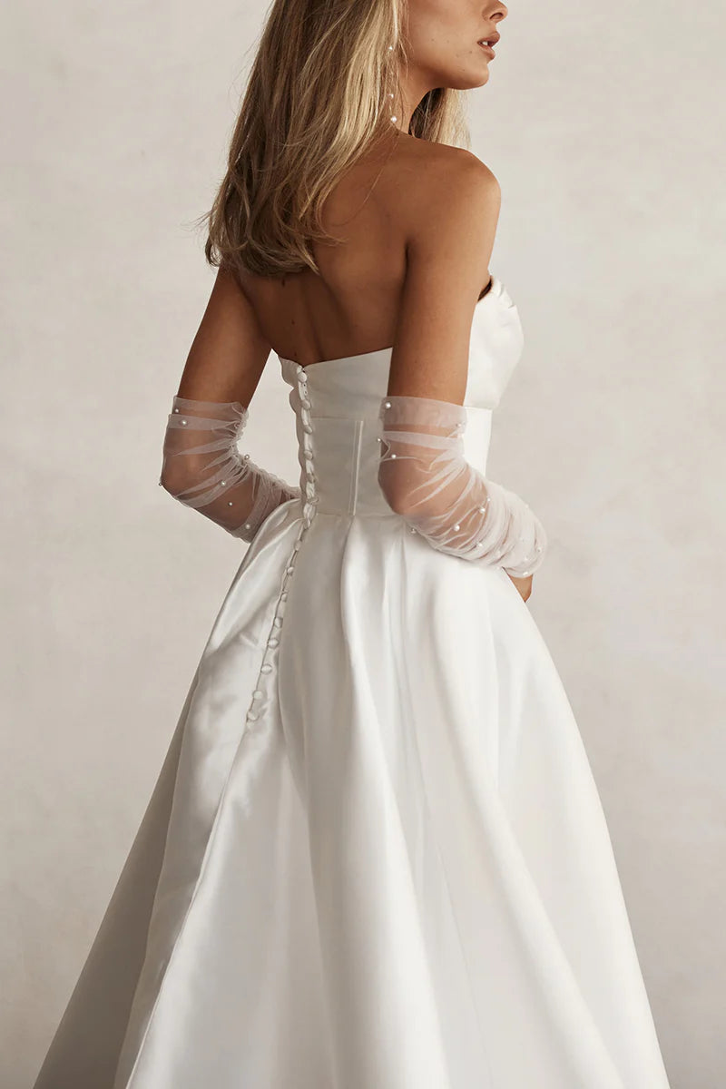 A-line sweetheart long sleeve satin pleated wedding dress, side view.