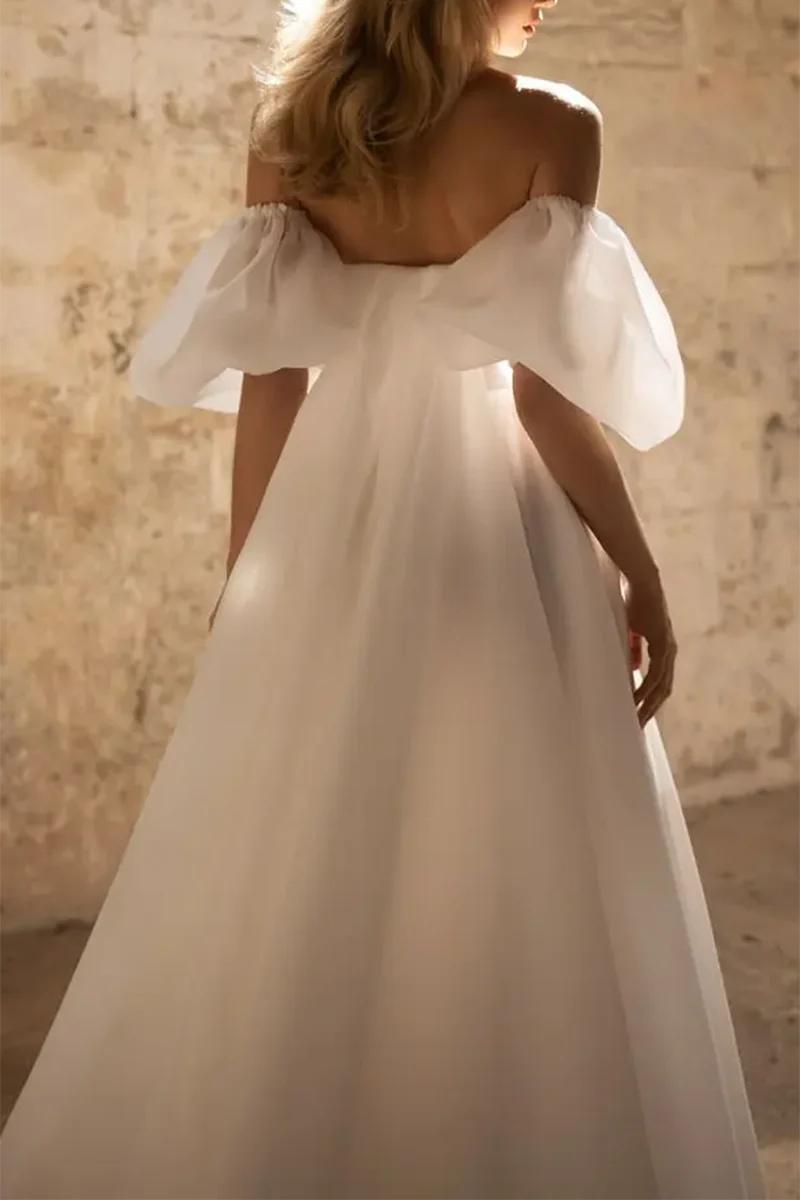 Close-up of the sweetheart neckline and short sleeves on a bridal gown.