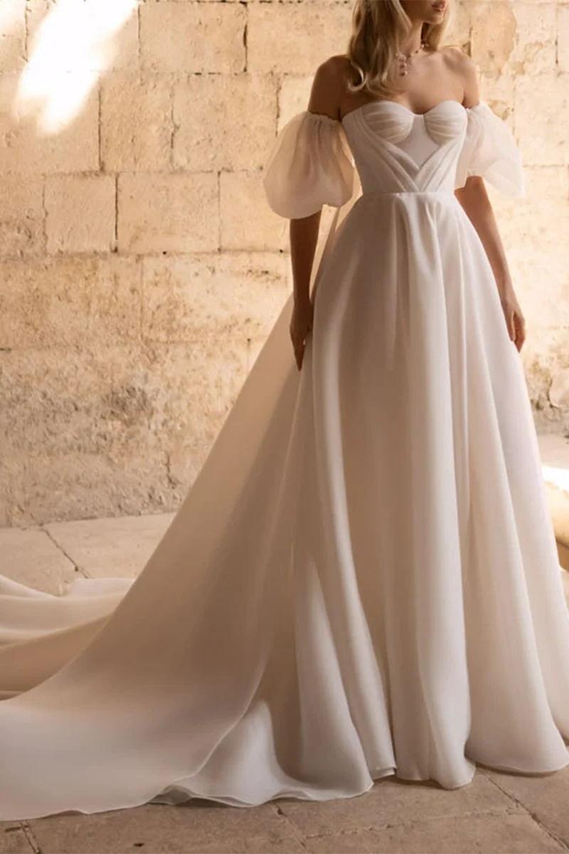 Side profile of a bride wearing an A-line wedding dress with a court train.