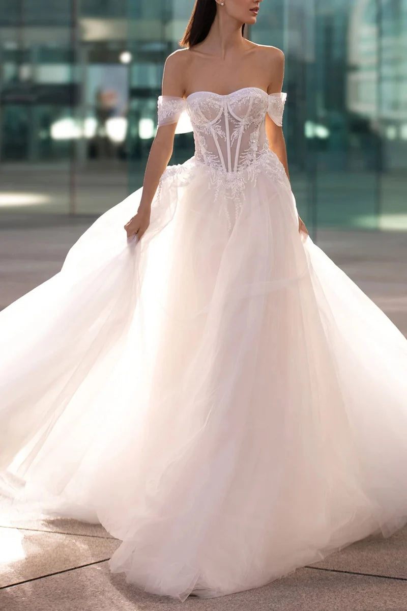 Full view of an A-line sweetheart wedding dress with bead appliques.