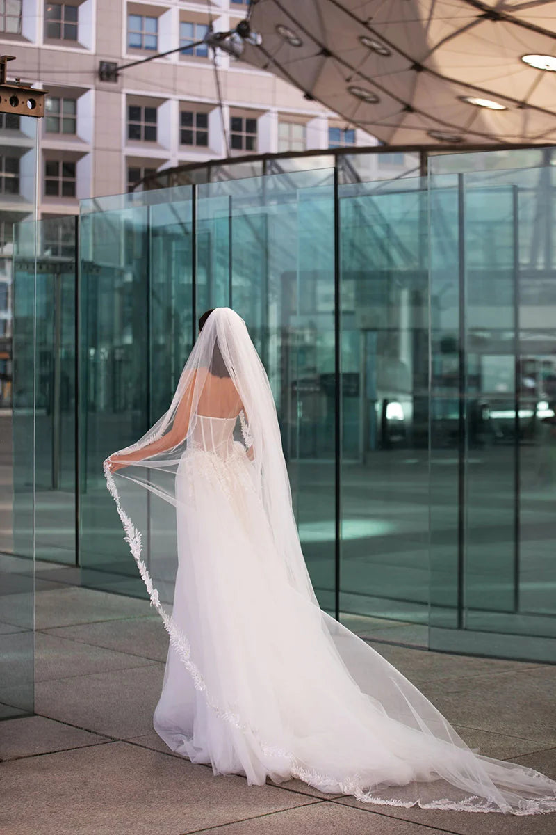 Back view of the elegant A-line wedding dress with a flowing train.