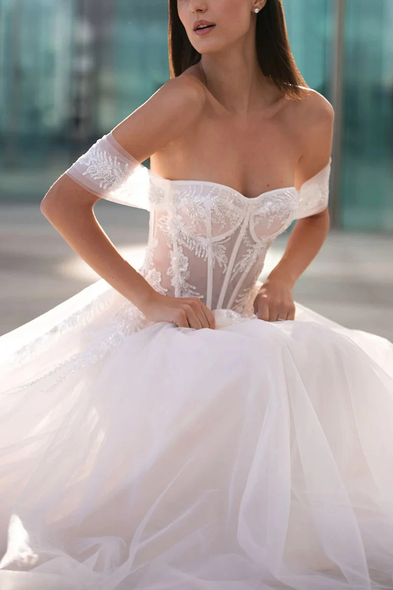 Side view of the A-line wedding dress, showcasing its silhouette and bead detailing.