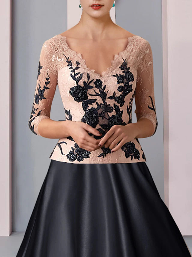 Close-up of lace appliques and satin fabric on the A-line dress.