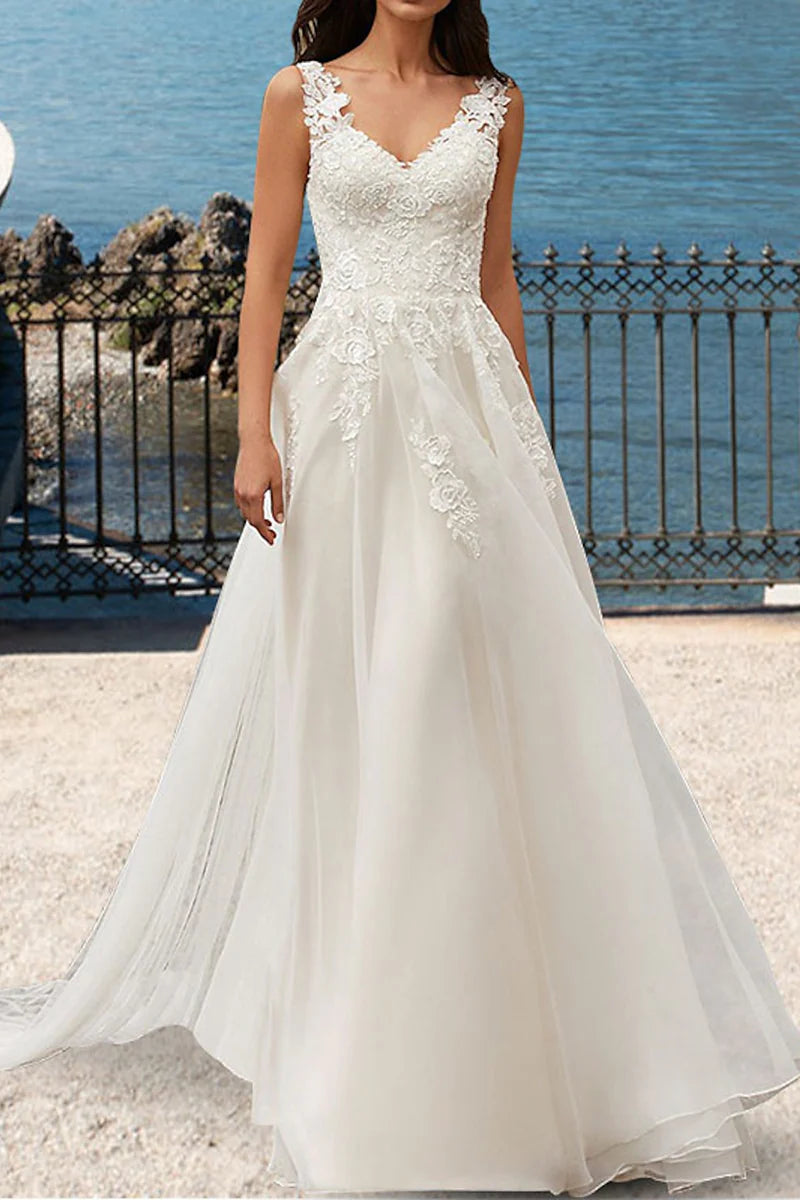 Elegant A-line V-neck wedding dress with lace appliques and a flowing court train.
