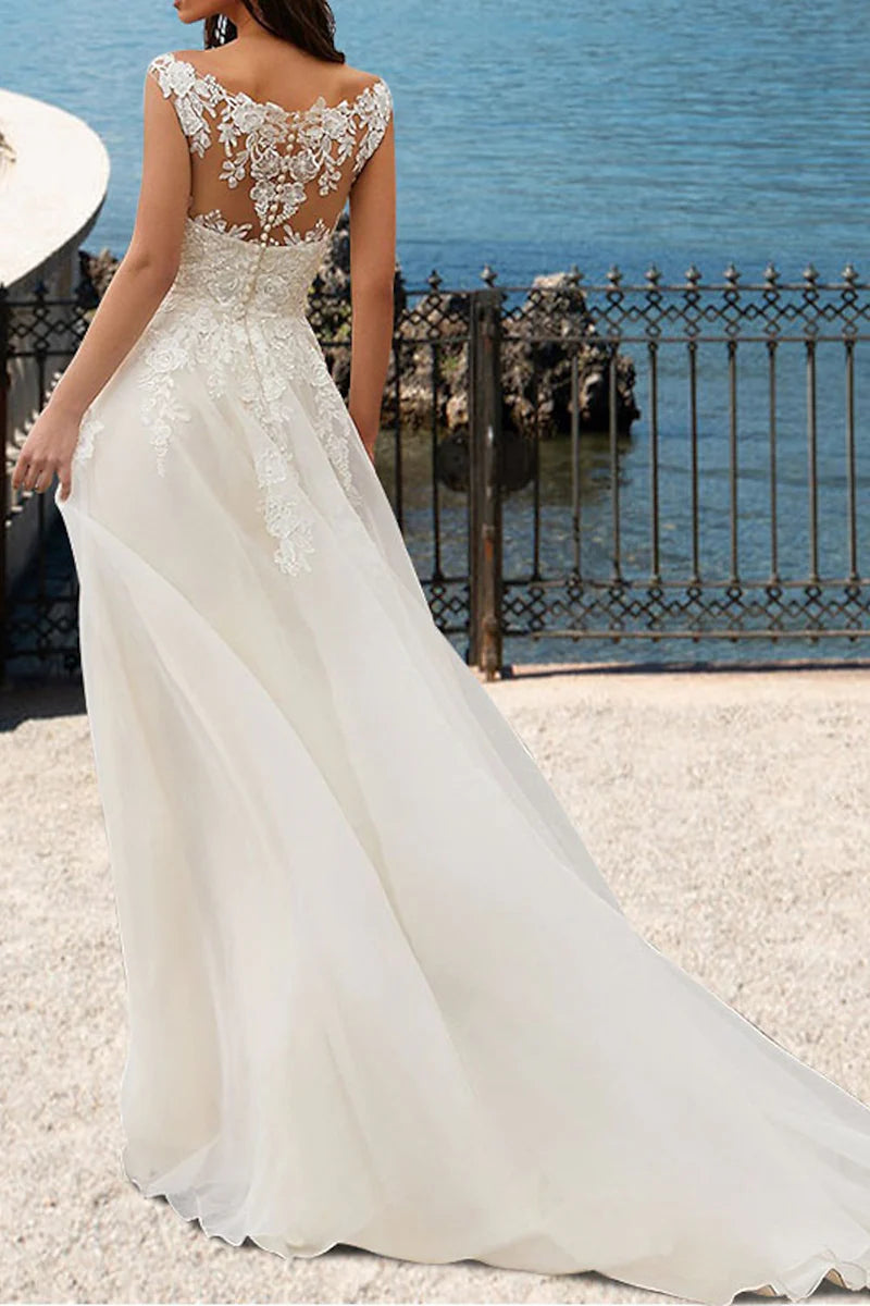 Side view of the A-line wedding dress, showcasing the delicate lace details and court train.