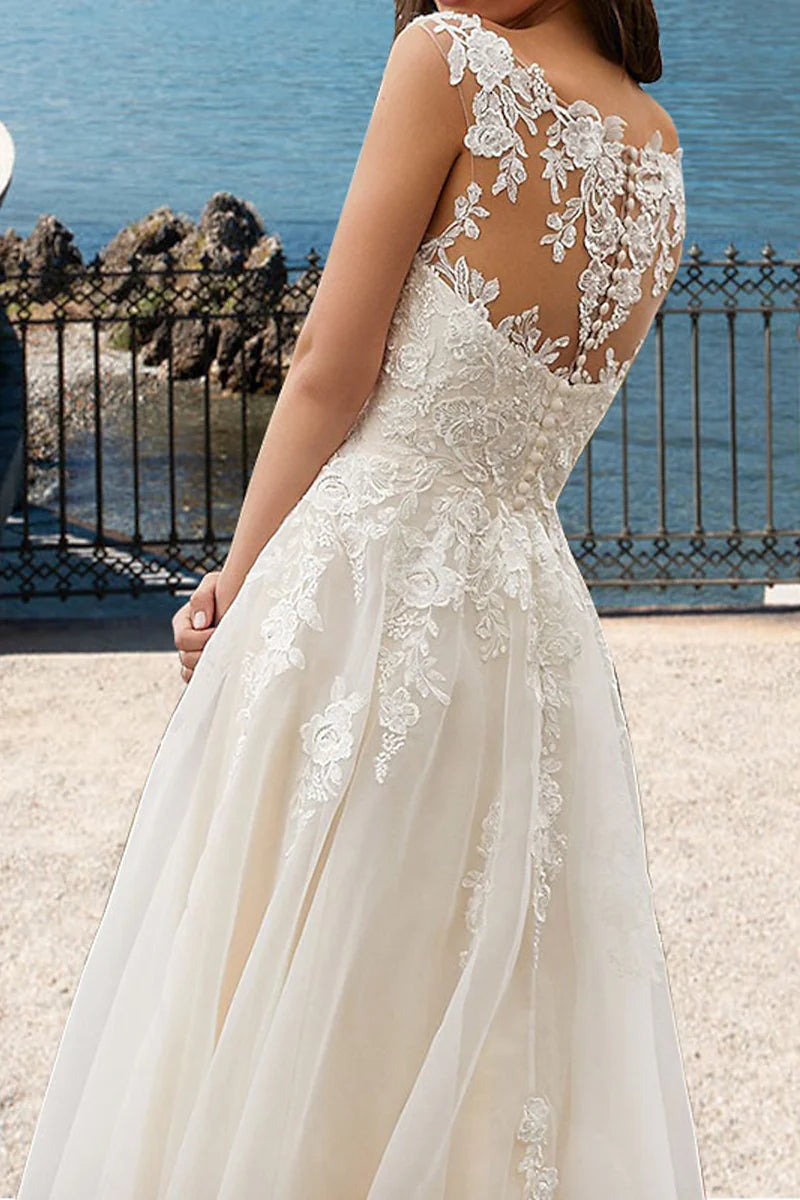 Close-up of the intricate lace appliques on the bodice of the V-neck wedding gown.