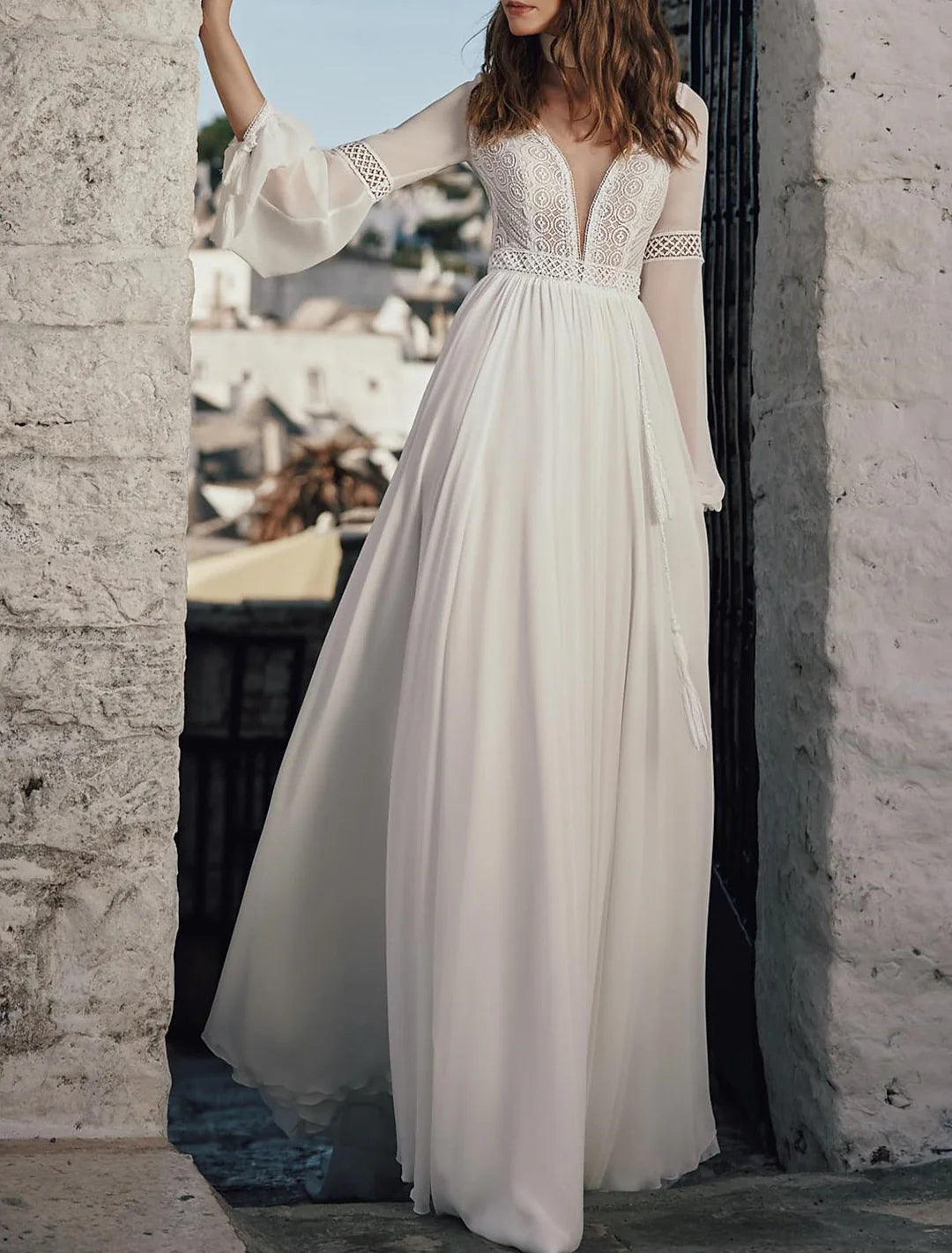 Side profile of an A-line V-neck lace wedding dress, highlighting intricate lace details.