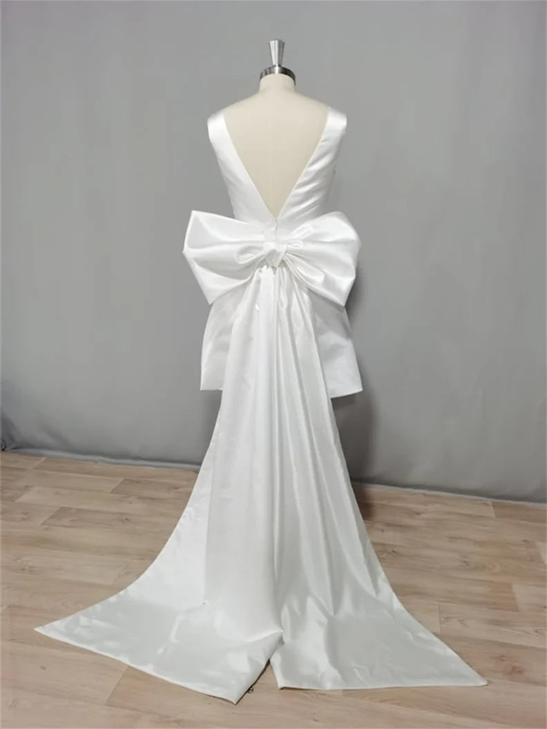 Close-up of the V-neckline and fabric detail of the mini wedding dress.
