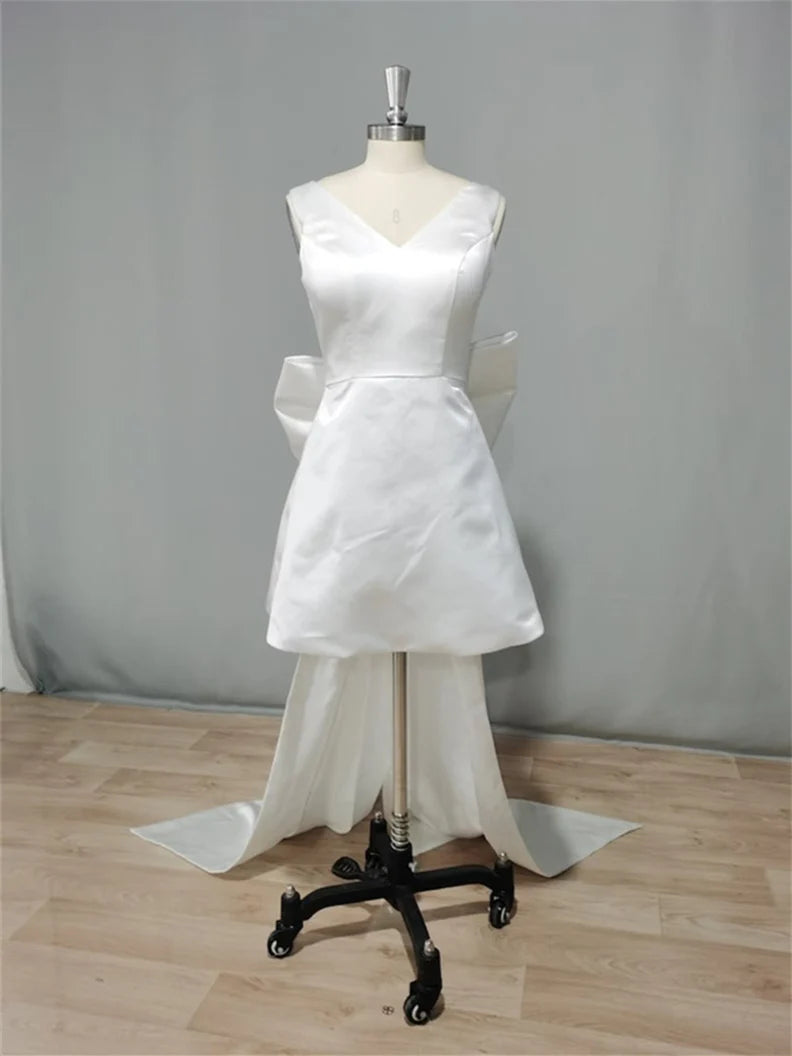Model posing elegantly in the A-line V-neck sleeveless mini wedding dress.