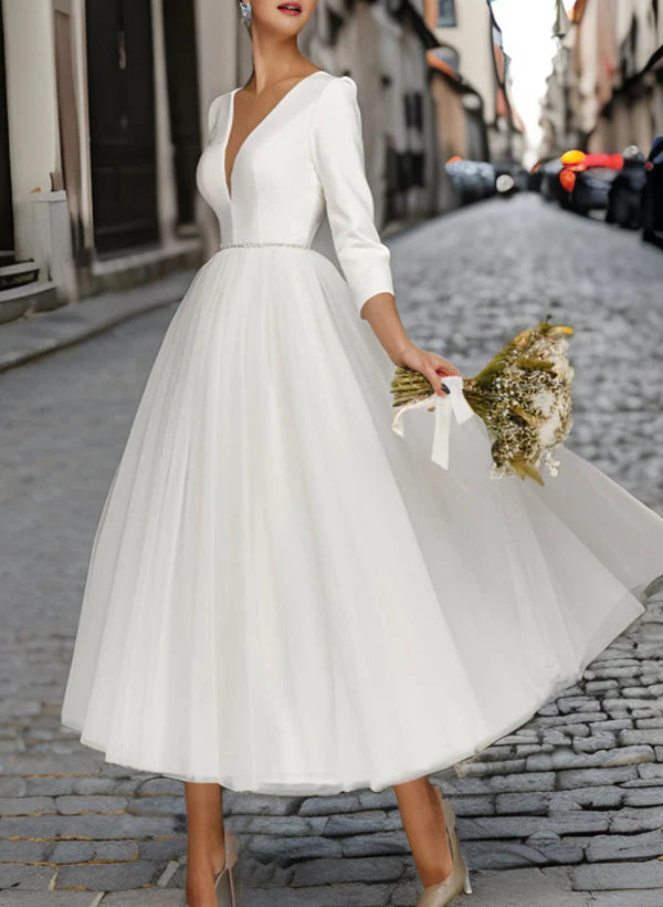 Elegant A-Line V-neck tea-length wedding dress with long sleeves, front view.