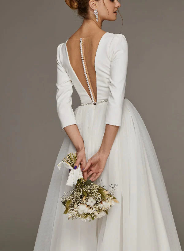 Back view of an A-Line V-neck tea-length wedding dress with long sleeves.