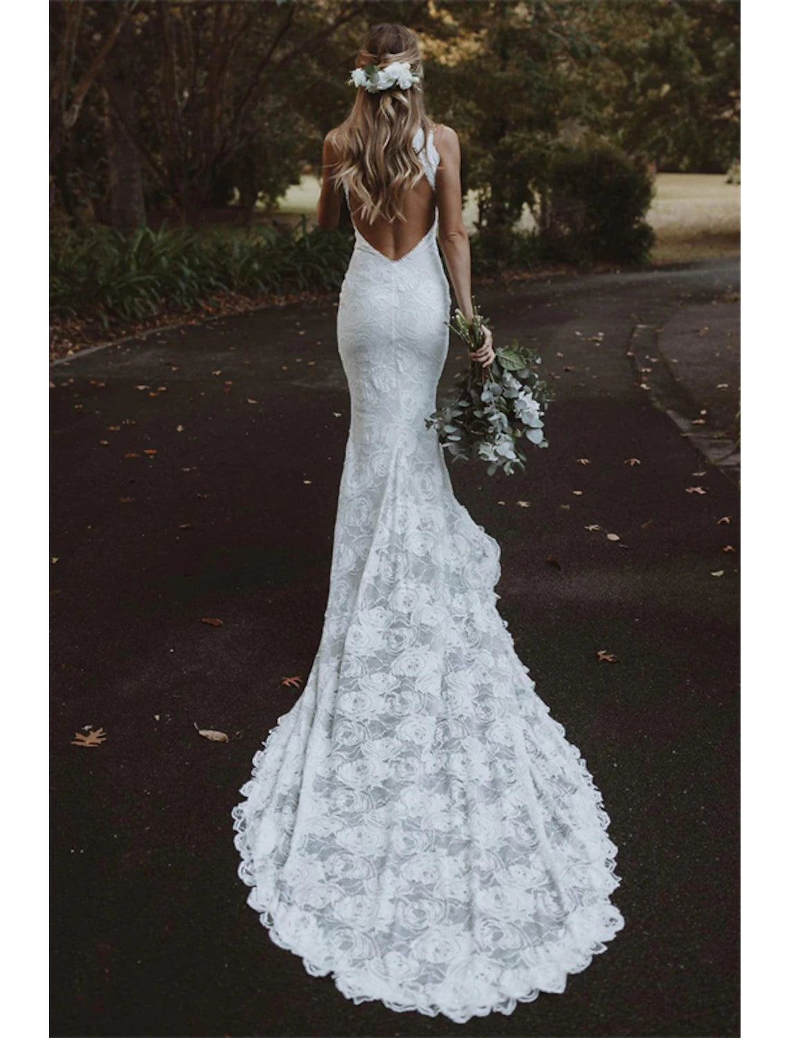 Boho mermaid wedding dress with open back and halter neckline.