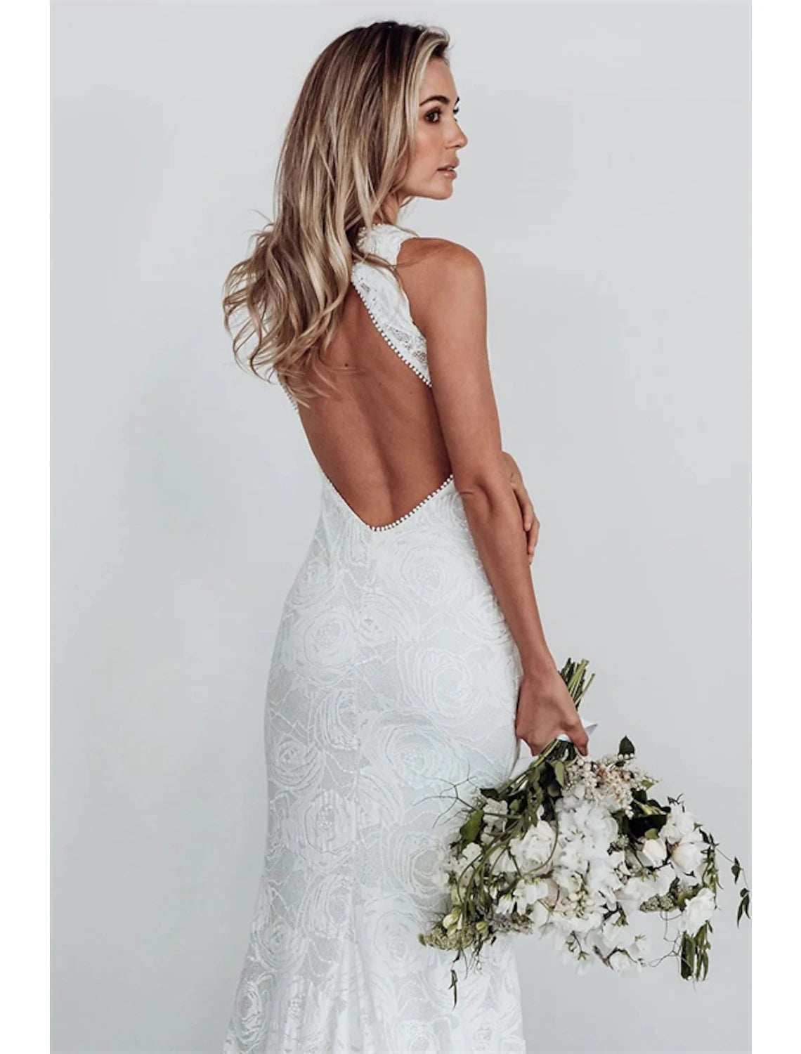 Back view of lace wedding dress with chapel train and appliques.