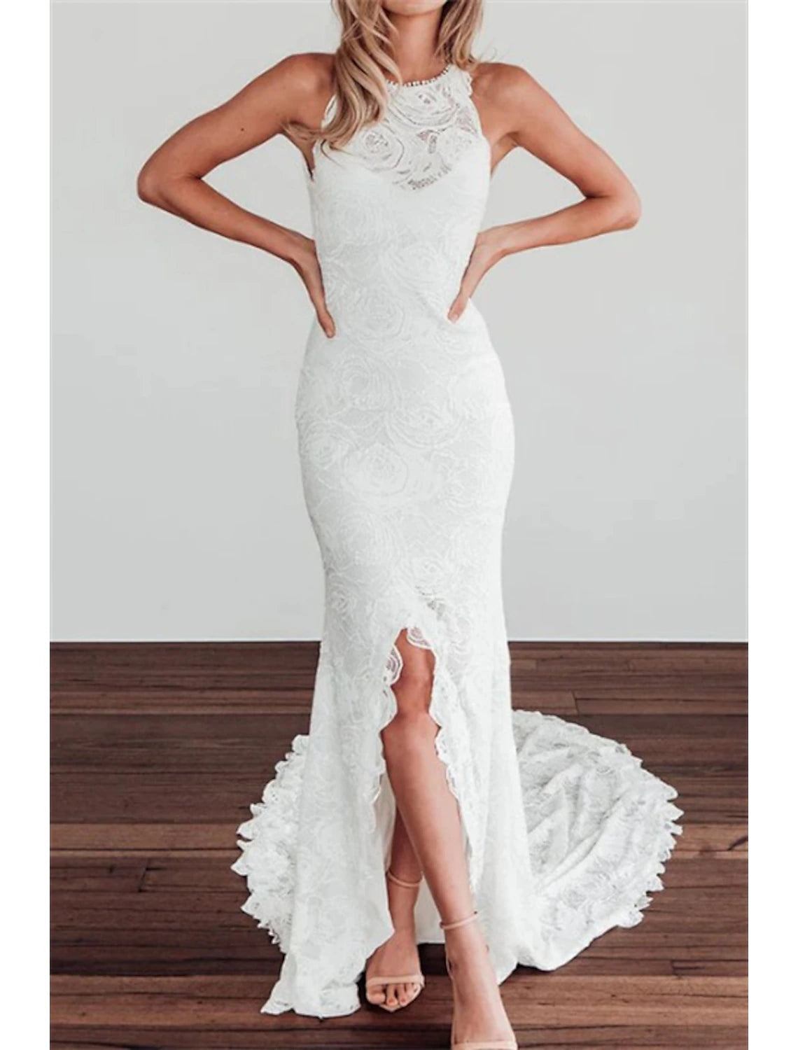 Side profile of a bride in a halter neck mermaid gown.