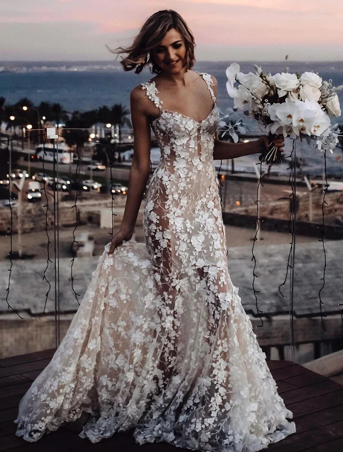 Back view of a mermaid bridal gown featuring a court train and regular straps.
