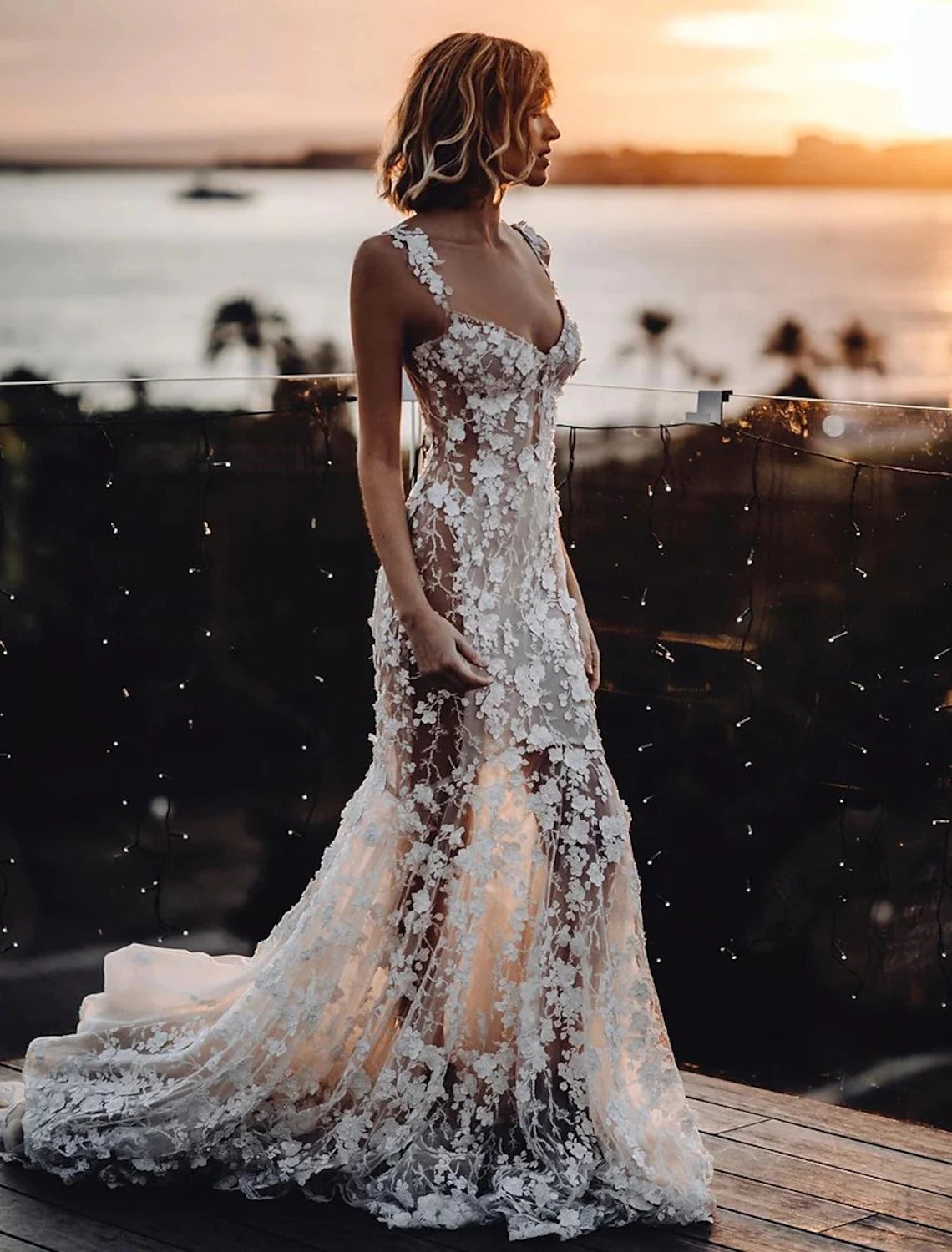 Close-up of delicate lace appliques on a sweetheart mermaid wedding dress.