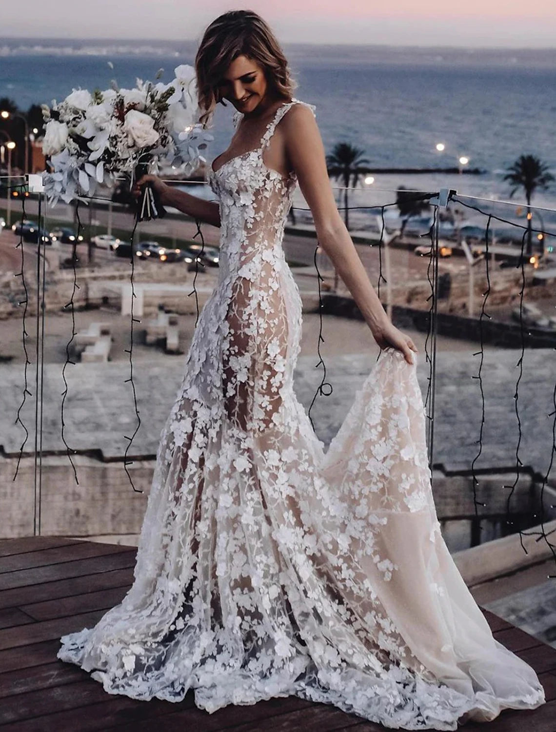 Full length view of a bride wearing a romantic boho mermaid wedding gown.