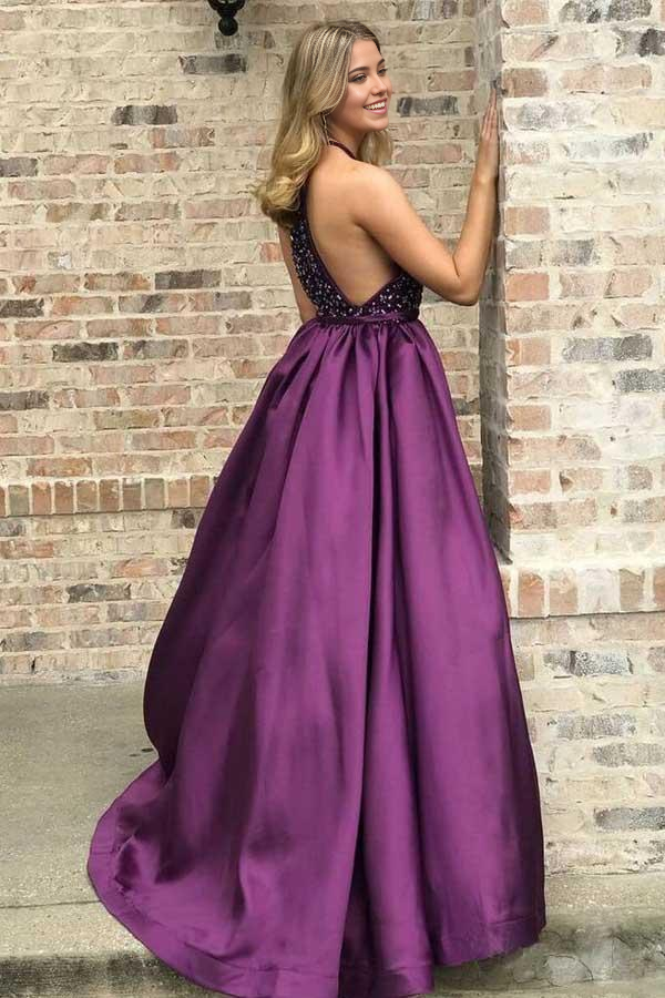 Back view of a purple long prom dress, showcasing the flowing A-line skirt and elegant design.