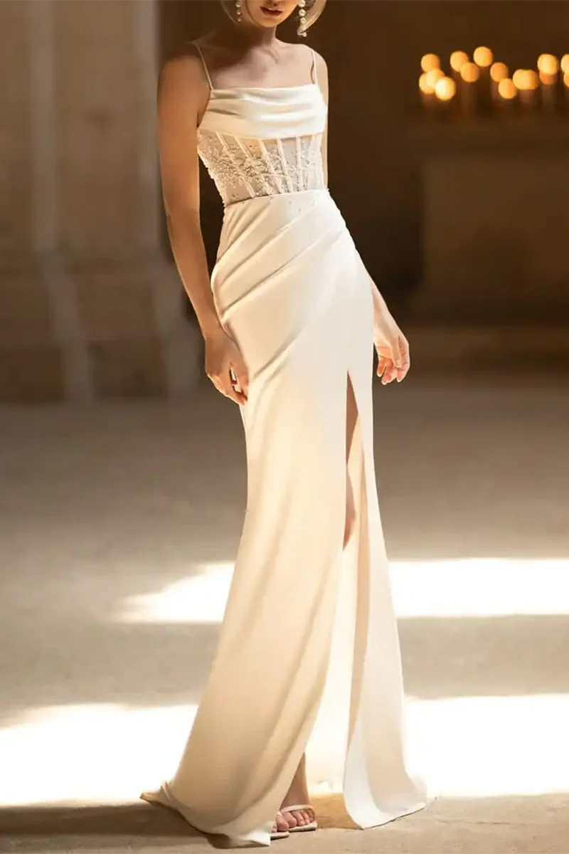 Elegant mermaid wedding dress with spaghetti straps, bead embellishments, and a thigh-high slit.