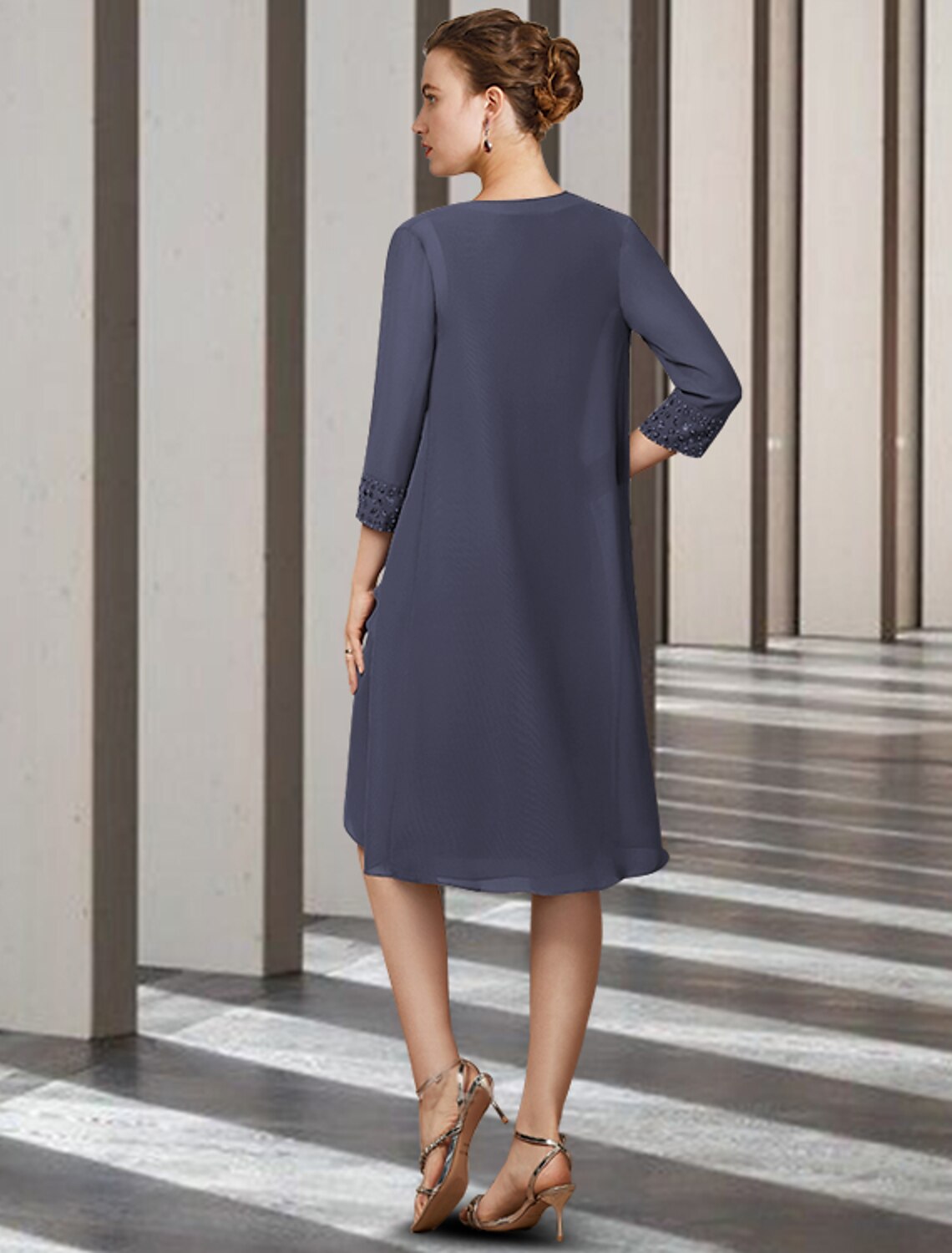 Woman posing in the elegant two-piece knee-length dress, highlighting the chiffon fabric.