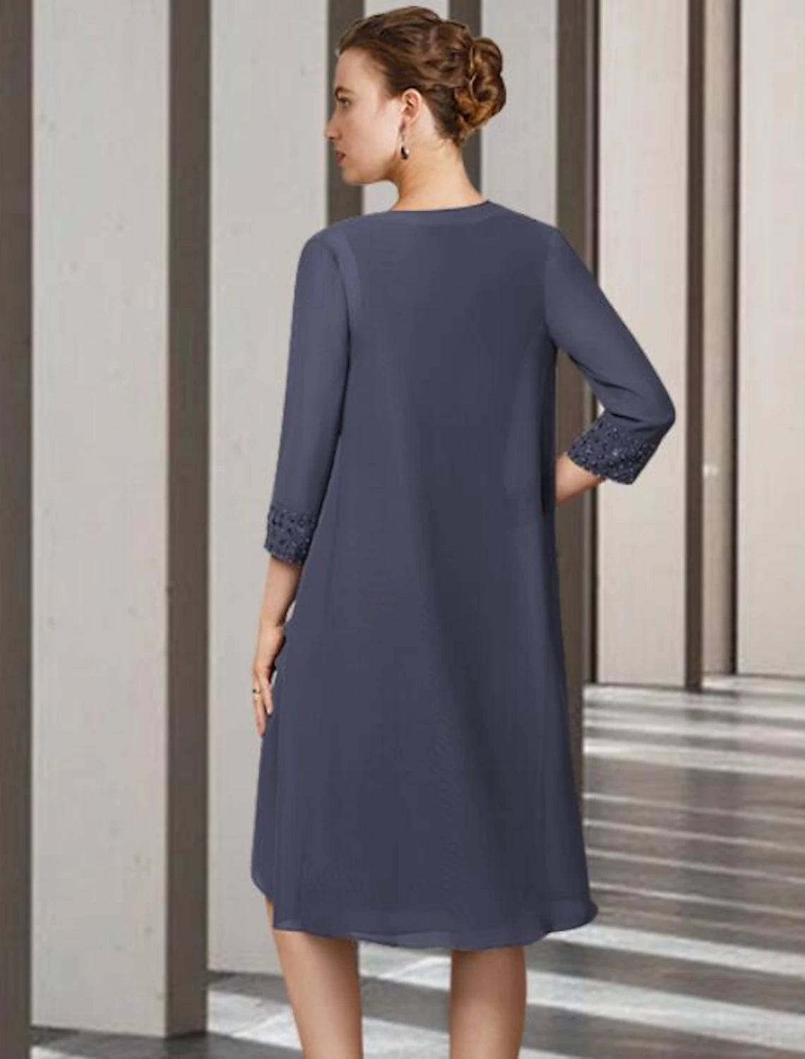Woman in the two-piece mother of the bride dress, demonstrating its comfortable fit.