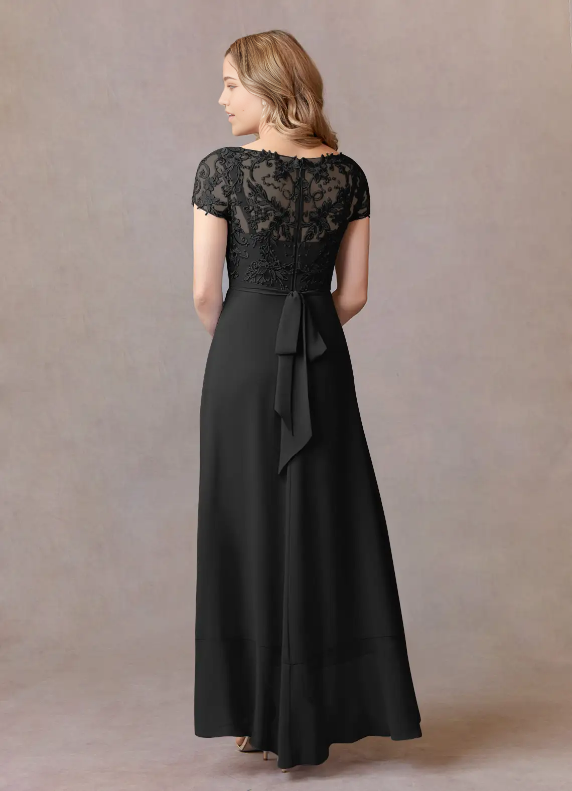 Black A-line V-neck dress with lace appliques, side view.