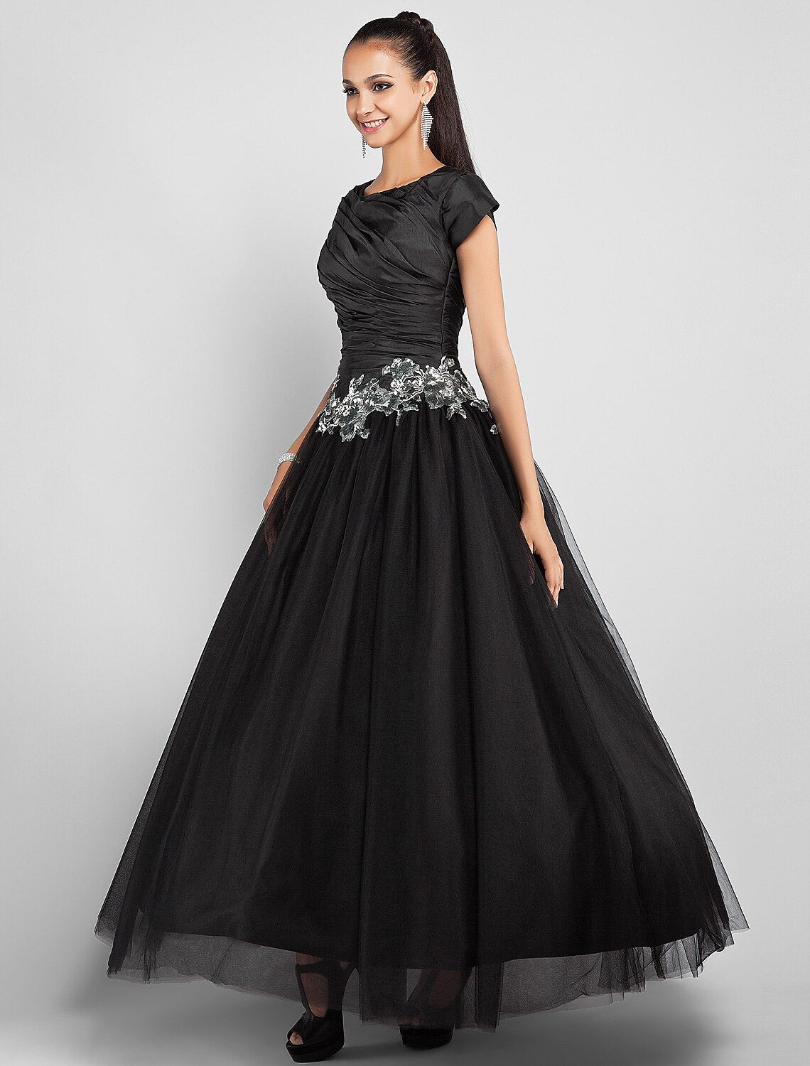 Full length view of the black taffeta ball gown, ideal for prom.