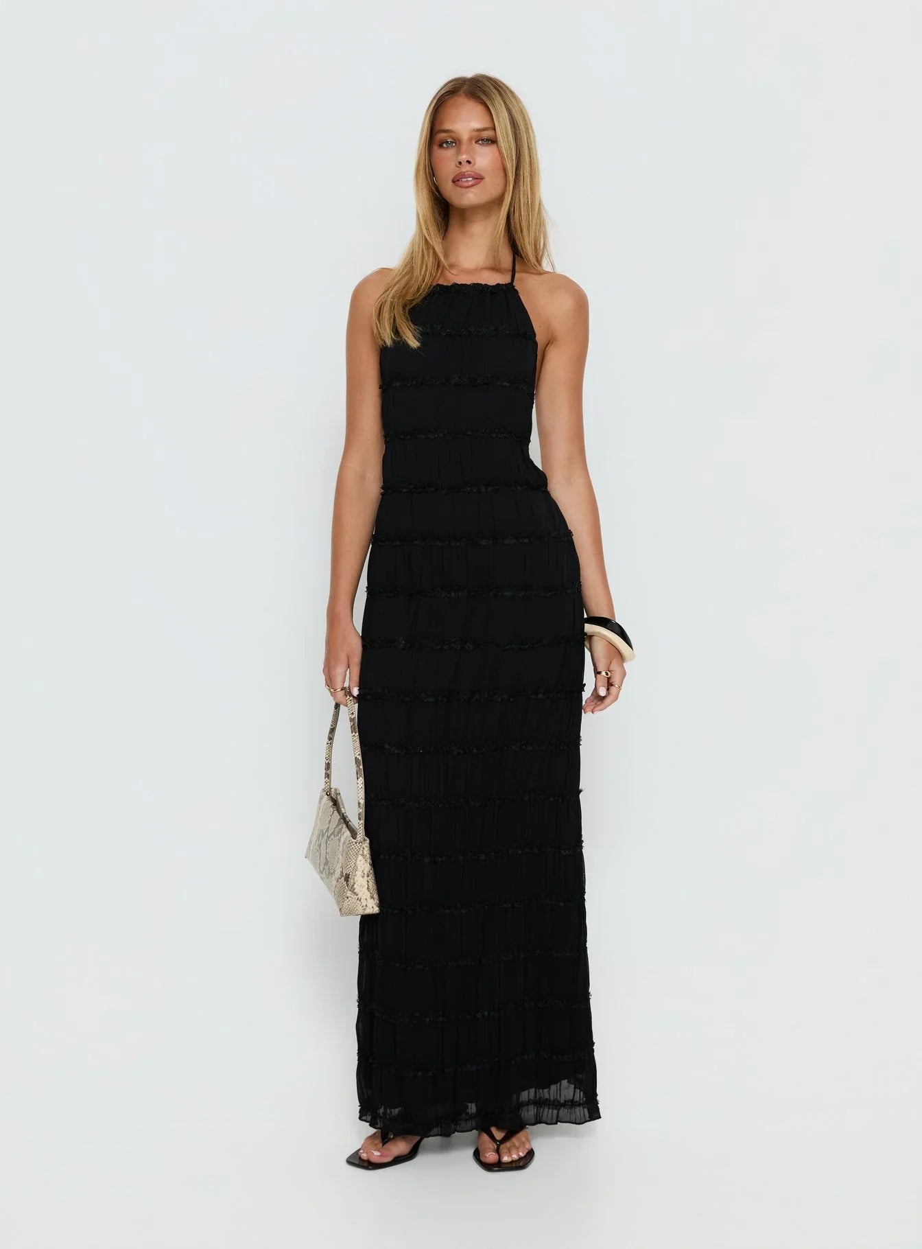 Black Halter Prom Dress with Tiered Ruffle Detail and Open Back for Formal Events and Prom Nights